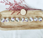 Detalle de velas relajantes con decoración de amatista y flores secas